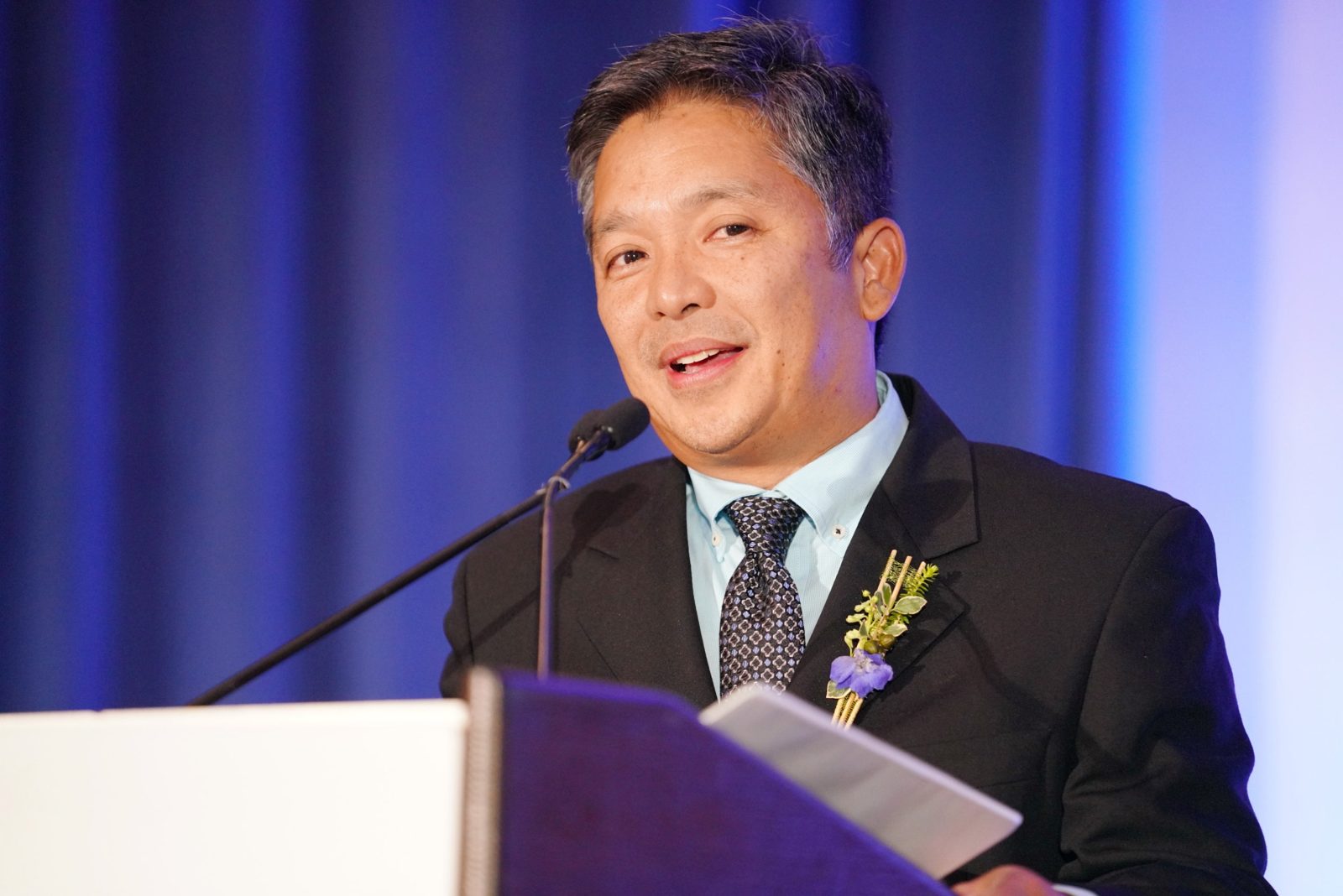 Renato Cruz Sogueco speaking at a podium at an industry event